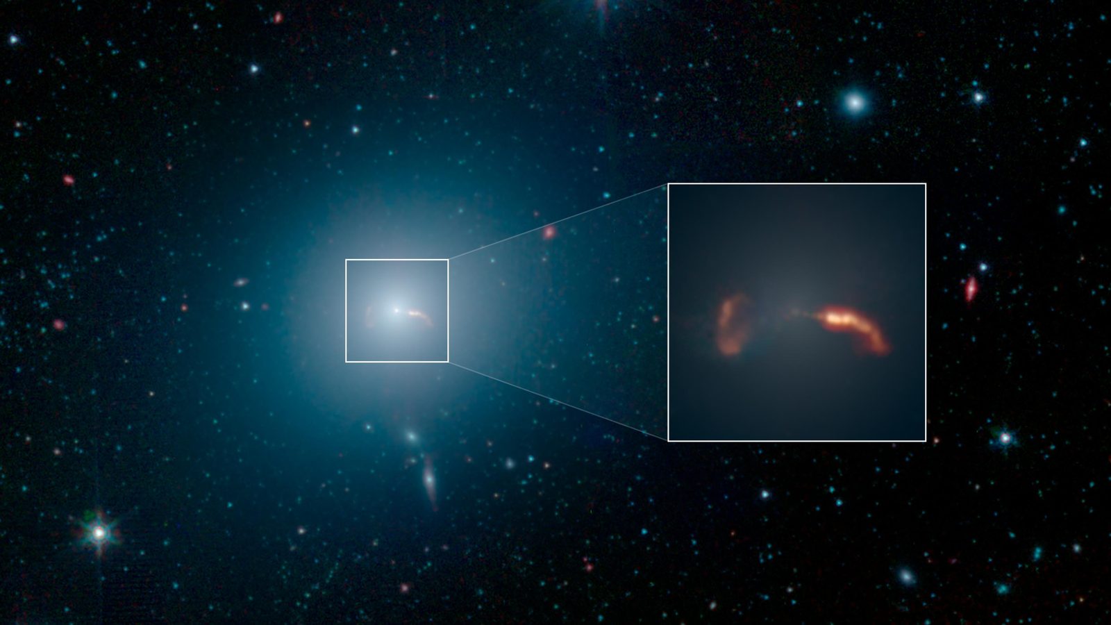Una galaxia elíptica como un halo azulado sobre un campo de estrellas, con un recuadro que amplía su centro y muestra dos rastros anaranjados de material.